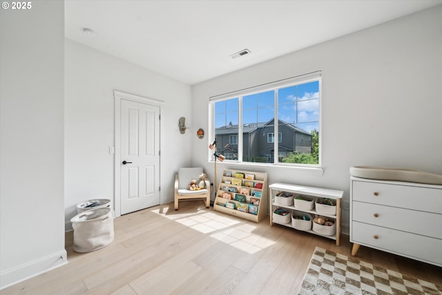 rec room featuring visible vents and wood finished floors