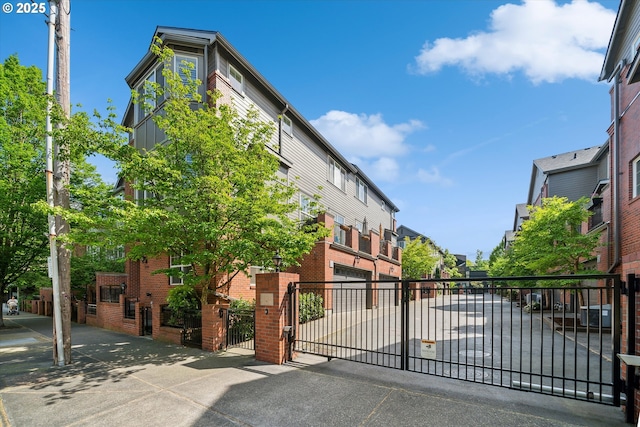 view of gate with a residential view and fence