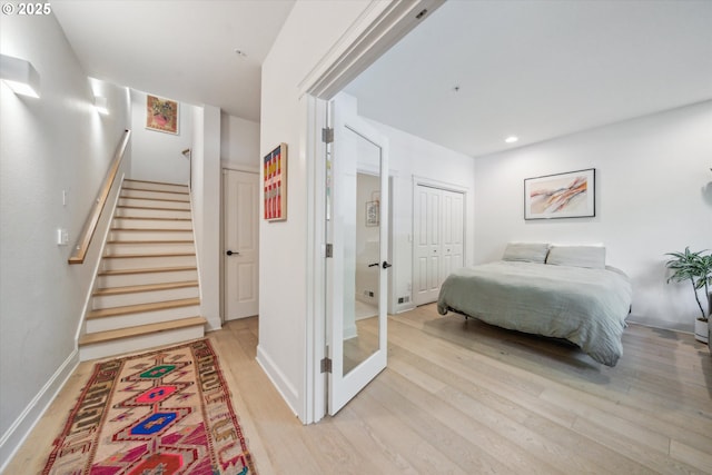 bedroom featuring light wood-style floors, baseboards, a closet, and recessed lighting