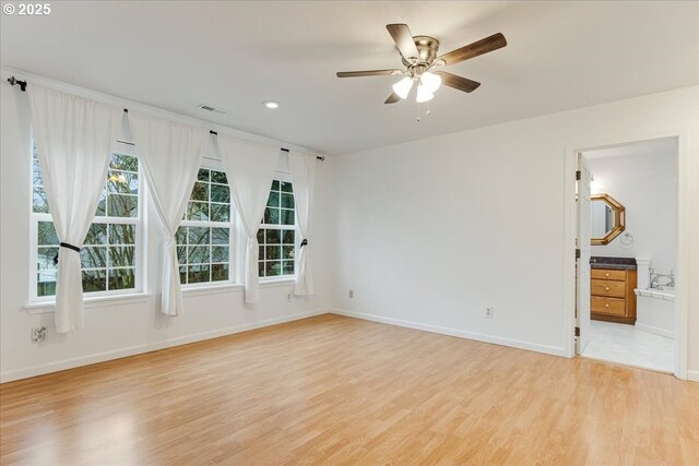 empty room with recessed lighting, light wood-type flooring, baseboards, visible vents, and a ceiling fan