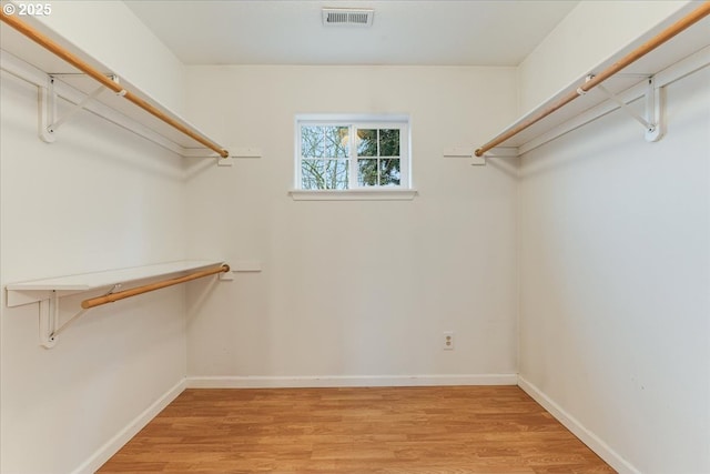 spacious closet with light wood finished floors and visible vents