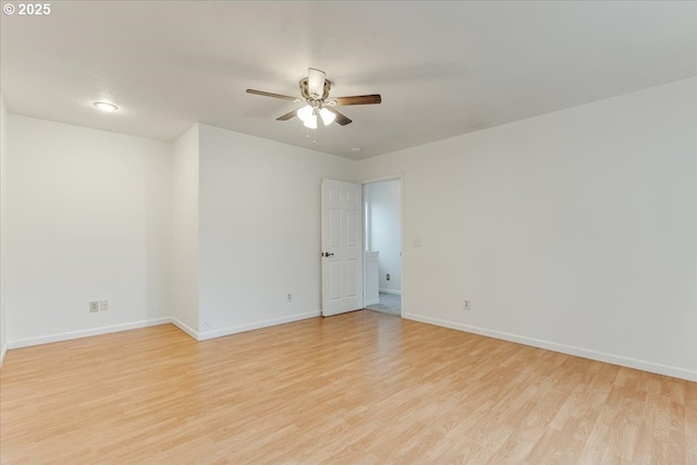 unfurnished room featuring baseboards, light wood finished floors, and ceiling fan