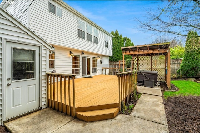 wooden deck featuring a hot tub and fence