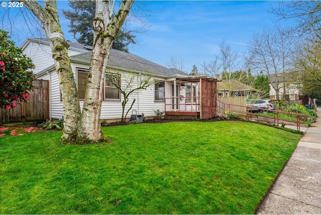 ranch-style house with fence and a front yard