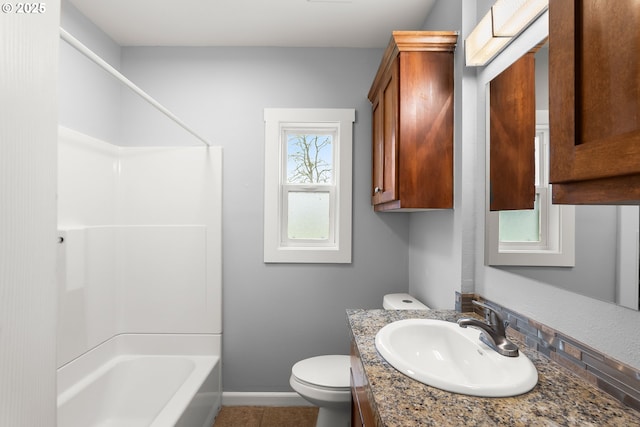 full bath with vanity, baseboards, tub / shower combination, tile patterned flooring, and toilet