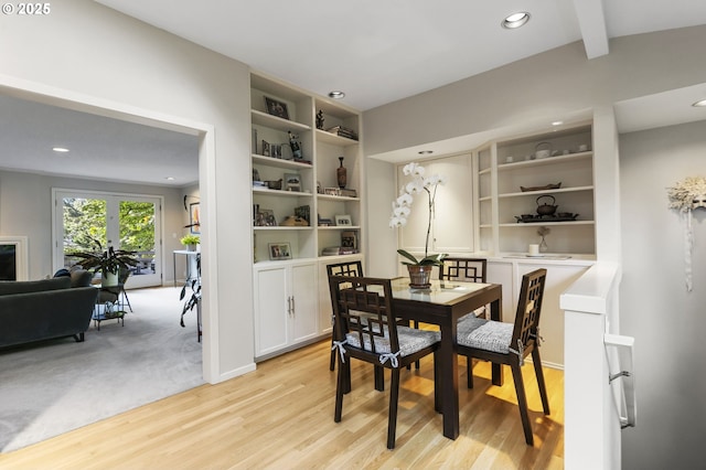 dining area with light wood-type flooring, recessed lighting, and beam ceiling