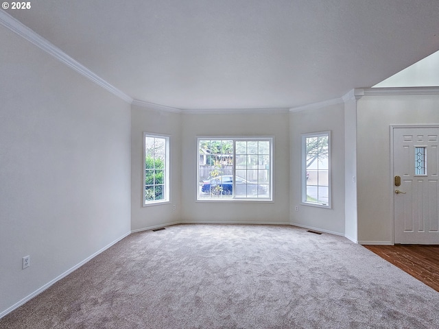 interior space with a healthy amount of sunlight, baseboards, and visible vents