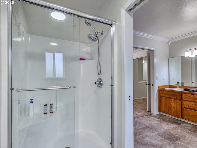 full bathroom with a stall shower, vanity, and crown molding