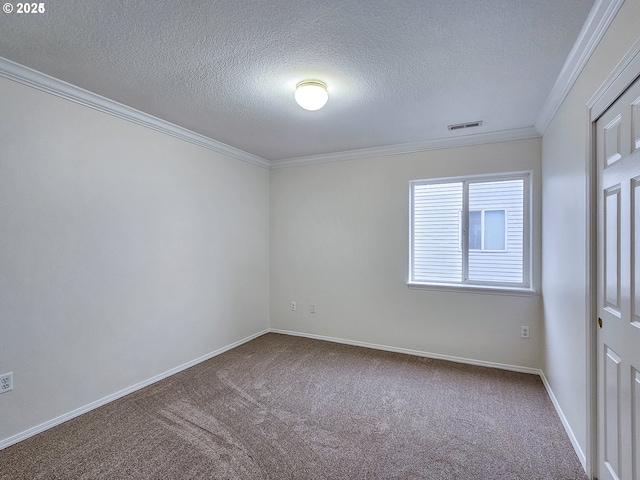 empty room with baseboards, visible vents, crown molding, and carpet flooring