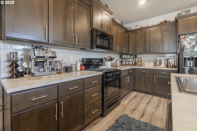 1850 NW Landon St, Mcminnville, OR 97128 - kitchen with black appliances, light countertops, decorative backsplash, light wood finished floors, and dark brown cabinetry
