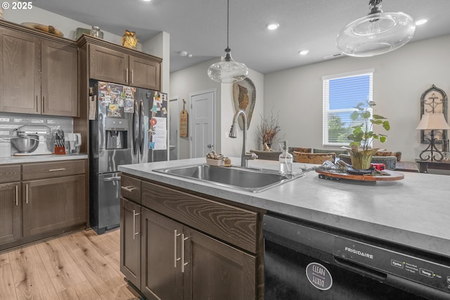 1850 NW Landon St, Mcminnville, OR 97128 - kitchen featuring black dishwasher, a sink, stainless steel refrigerator with ice dispenser, pendant lighting, and light wood finished floors