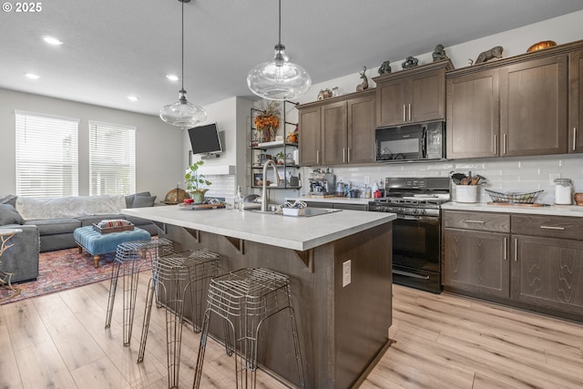 1850 NW Landon St, Mcminnville, OR 97128 - kitchen featuring black appliances, a sink, light countertops, backsplash, and recessed lighting