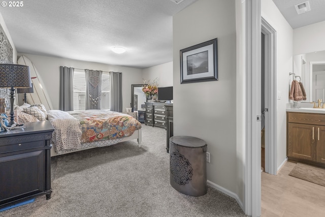1850 NW Landon St, Mcminnville, OR 97128 - bedroom with a sink, a textured ceiling, light colored carpet, and baseboards