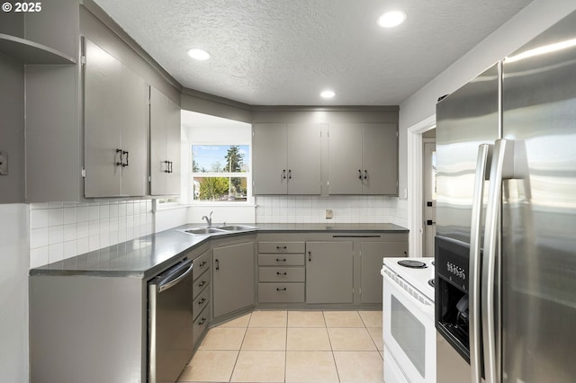 320 SE 106th Ave, Portland, OR 97216 - kitchen with appliances with stainless steel finishes, gray cabinets, dark countertops, a textured ceiling, and recessed lighting