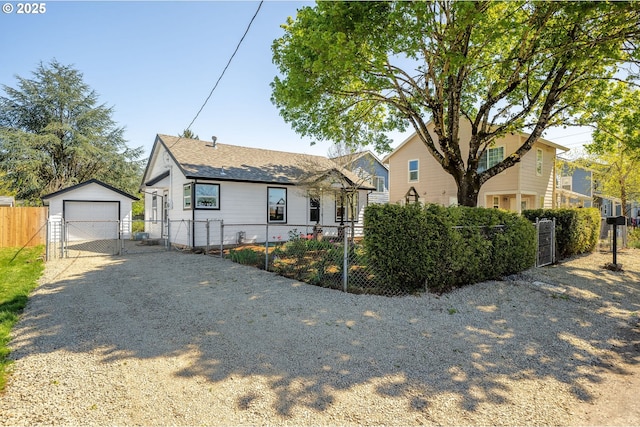 320 SE 106th Ave, Portland, OR 97216 - view of front of property with an outbuilding, gravel driveway, a detached garage, a gate, and roof with shingles