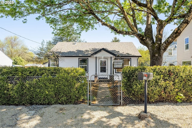 320 SE 106th Ave, Portland, OR 97216 - view of front of home with a gate, a fenced front yard, and roof with shingles