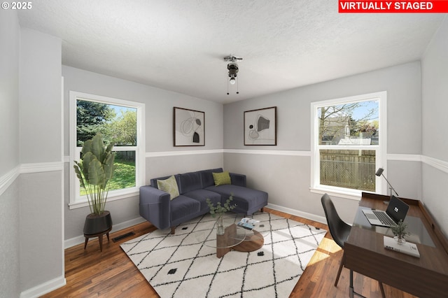 320 SE 106th Ave, Portland, OR 97216 - living area with wood finished floors and a textured ceiling