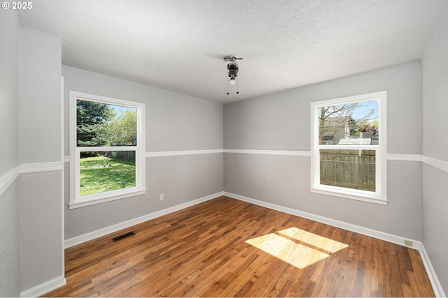 320 SE 106th Ave, Portland, OR 97216 - spare room with wood finished floors and a textured ceiling