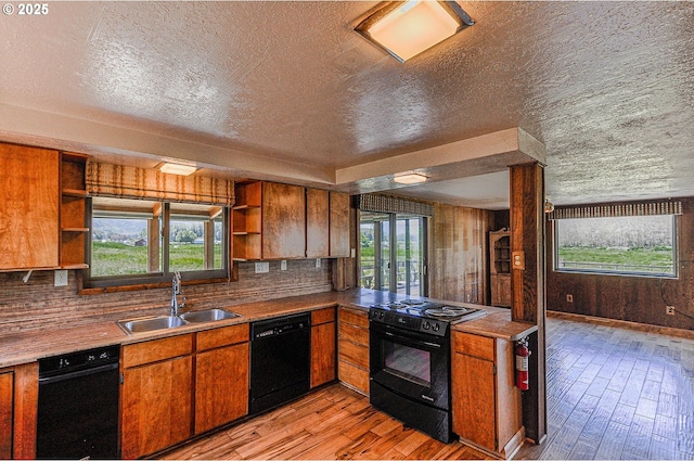 77993 Point Adams Rd, Clatskanie, OR 97016 - kitchen with black appliances, open shelves, light wood-style floors, backsplash, and a textured ceiling