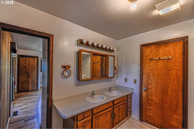 77993 Point Adams Rd, Clatskanie, OR 97016 - bathroom with double vanity and wood finished floors