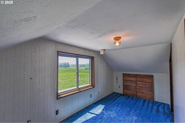 77993 Point Adams Rd, Clatskanie, OR 97016 - additional living space featuring vaulted ceiling, a textured ceiling, and carpet floors