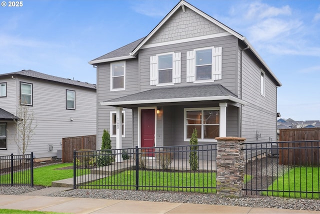 view of front of house with a fenced front yard, a porch, and a front lawn