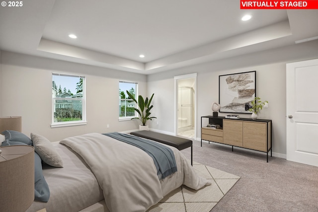 bedroom with recessed lighting, light colored carpet, baseboards, and a tray ceiling