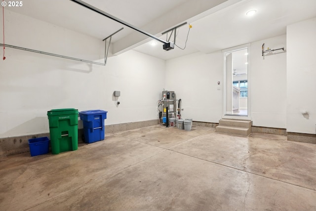 garage featuring hybrid water heater and a garage door opener