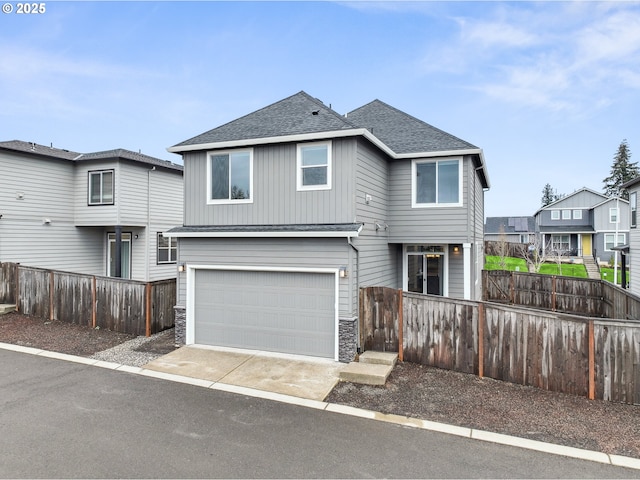 view of front of property featuring a shingled roof, fence, concrete driveway, a garage, and stone siding