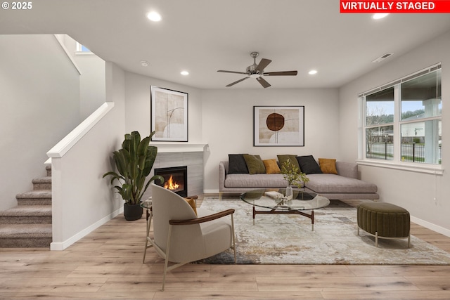 living room with stairs, wood finished floors, recessed lighting, and visible vents