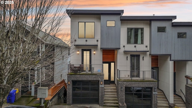 contemporary house featuring brick siding and stairway