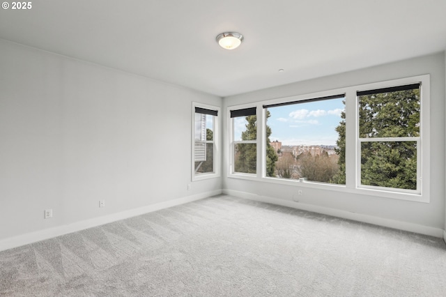 carpeted empty room with baseboards