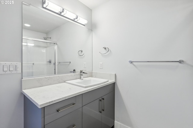 full bath with vanity and an enclosed shower