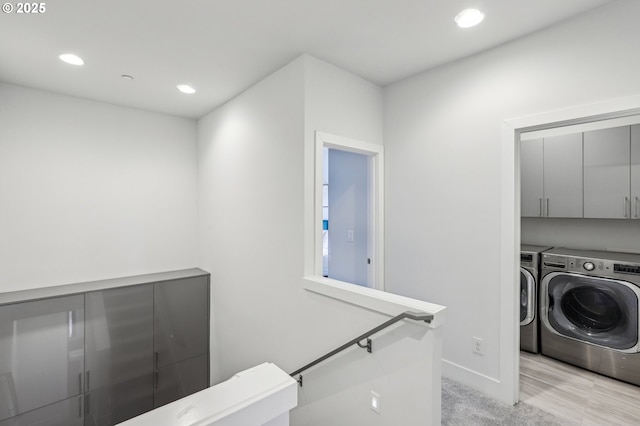 laundry area featuring light carpet, cabinet space, baseboards, independent washer and dryer, and recessed lighting