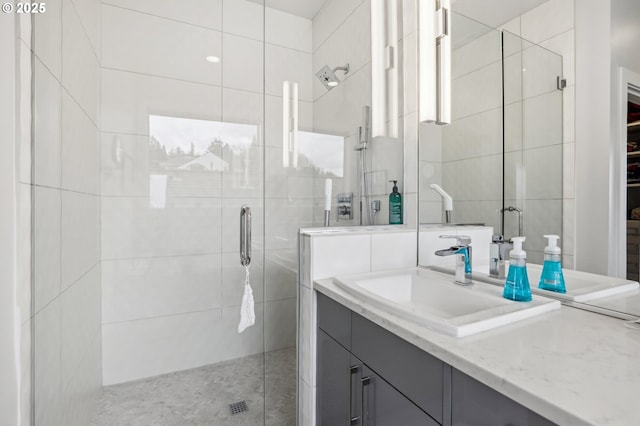 bathroom with a stall shower, vanity, and tile walls