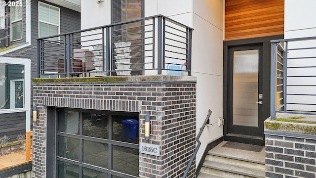 doorway to property with brick siding