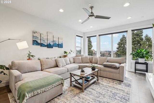 living area featuring light wood-type flooring, ceiling fan, and recessed lighting