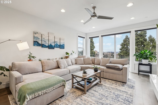 living room with plenty of natural light, a ceiling fan, and recessed lighting