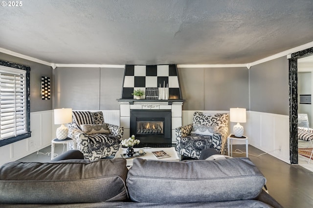 living room with ornamental molding and a textured ceiling