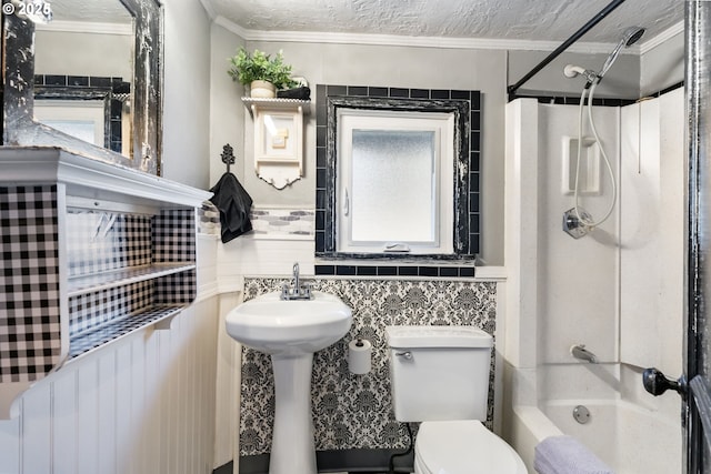 bathroom with crown molding, a textured ceiling, shower / tub combination, and toilet