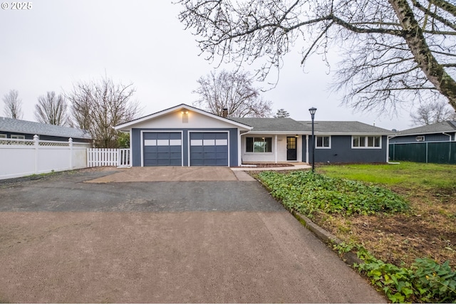 single story home featuring a front yard and a garage