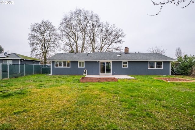 rear view of property with a yard and a patio