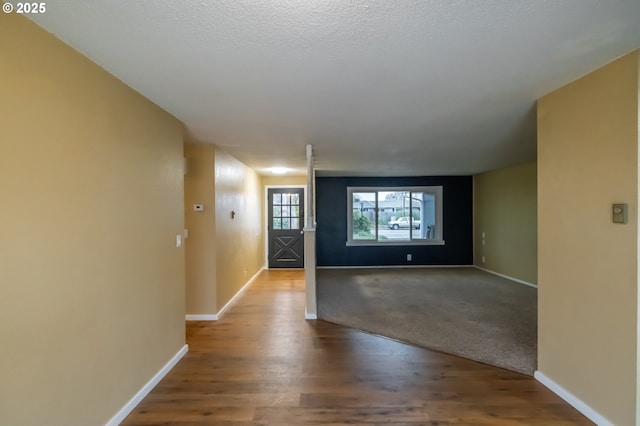 interior space featuring a textured ceiling and hardwood / wood-style flooring