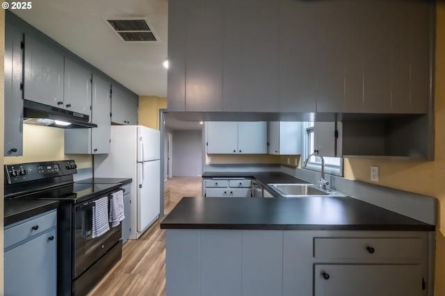 kitchen with white fridge, gray cabinetry, electric range, light wood-type flooring, and sink