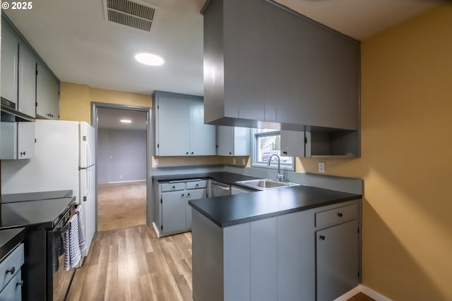 kitchen with sink, gray cabinets, range with electric cooktop, light wood-type flooring, and stainless steel dishwasher