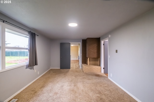 unfurnished room featuring light colored carpet