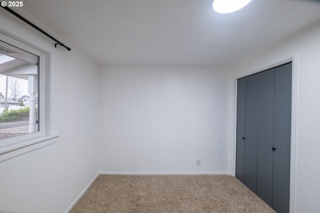 unfurnished bedroom featuring a closet and carpet flooring