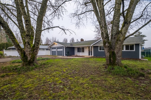 ranch-style home with a garage and a front yard