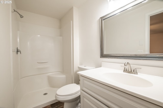 bathroom with toilet, a shower, and vanity