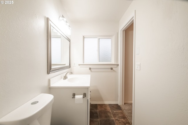 bathroom featuring toilet and vanity